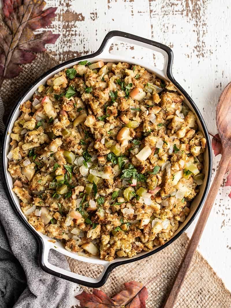 Take a Thanksgiving dinner short cut by upgrading a boxed stuffing mix with fresh ingredients for more flavor, texture, and visual appeal. BudgetBytes.com A casserole dish full of Apple Walnut Stuffing with a wooden spoon on the side