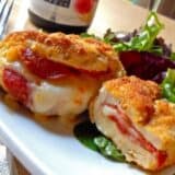Pepperoni stuffed chicken breast served on a plate.