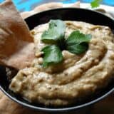 Baba ganoush on a bowl served with pita bread.
