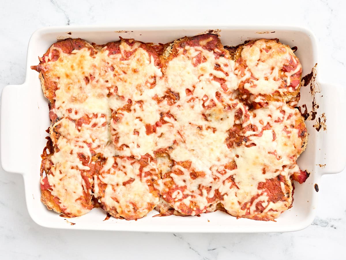 Freshly baked eggplant parmesan in a baking dish.