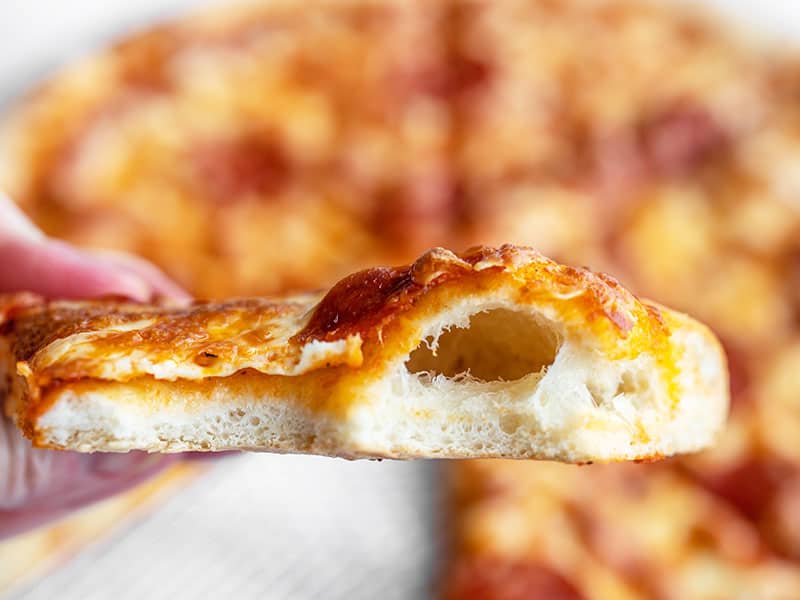 Homemade pizza dough is easy and costs pennies on the dollar compared to store bought. Make a batch now and freeze it for later! Budgetbytes.com Close up of a bubble in a slice of pizza