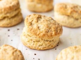Side view of baked biscuits on a baking sheet