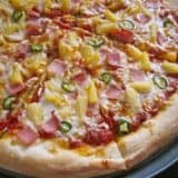 Spicy Hawaiian pizza topped with pineapple and ham.