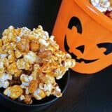 Nutty caramel corn with a festive pumpkin backdrop.
