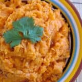 Close-up of chipotle sweet potatoes with herbs.