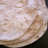 Low-fat flour tortillas stacked on a table.