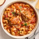 Overhead view of a bowl of hearty meatball soup.