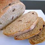 Close-up of sliced olive bread on a board.