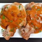 Apricot pork chops displayed on a plate.