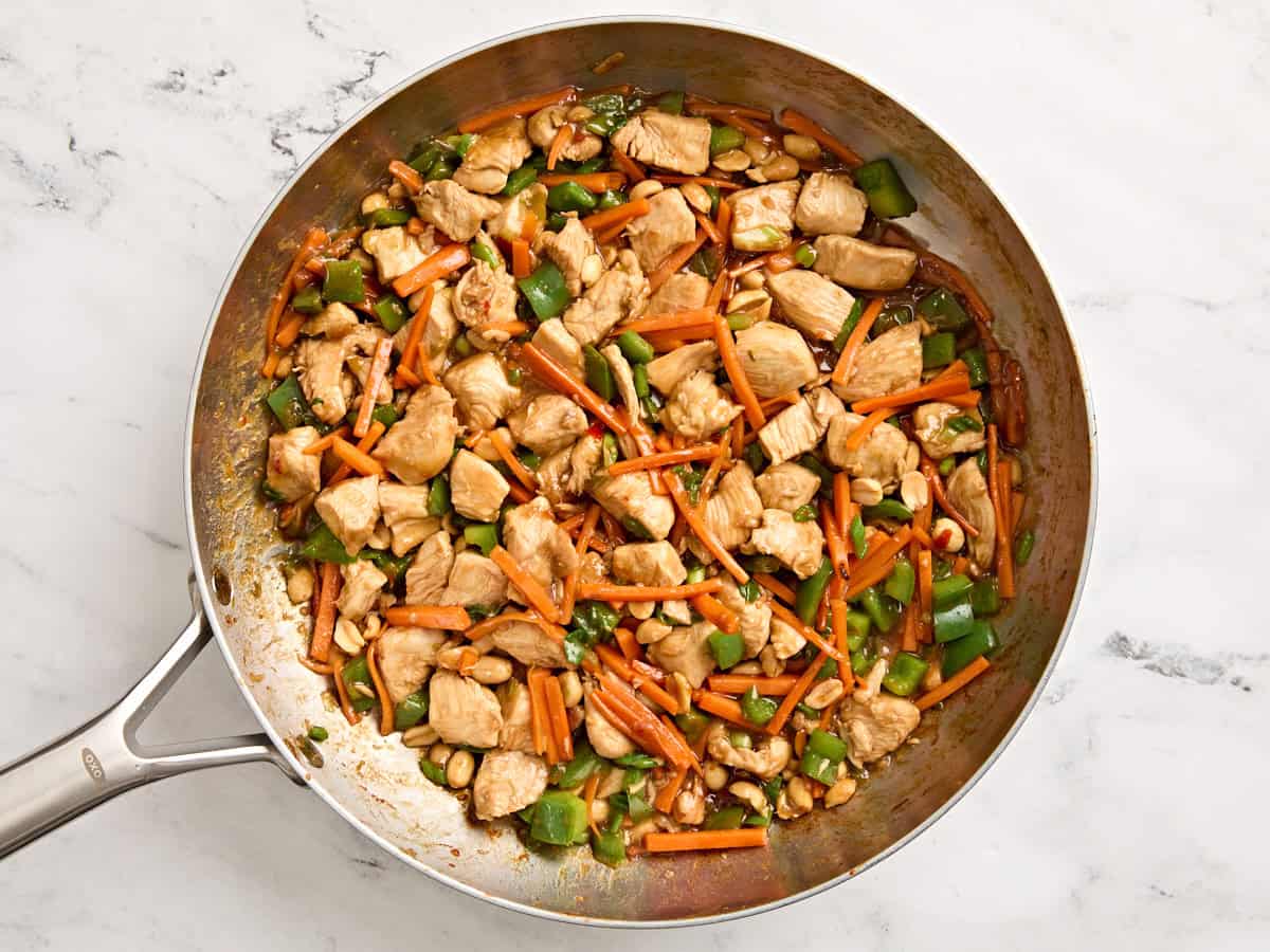 Finished kung pao chicken in a skillet.