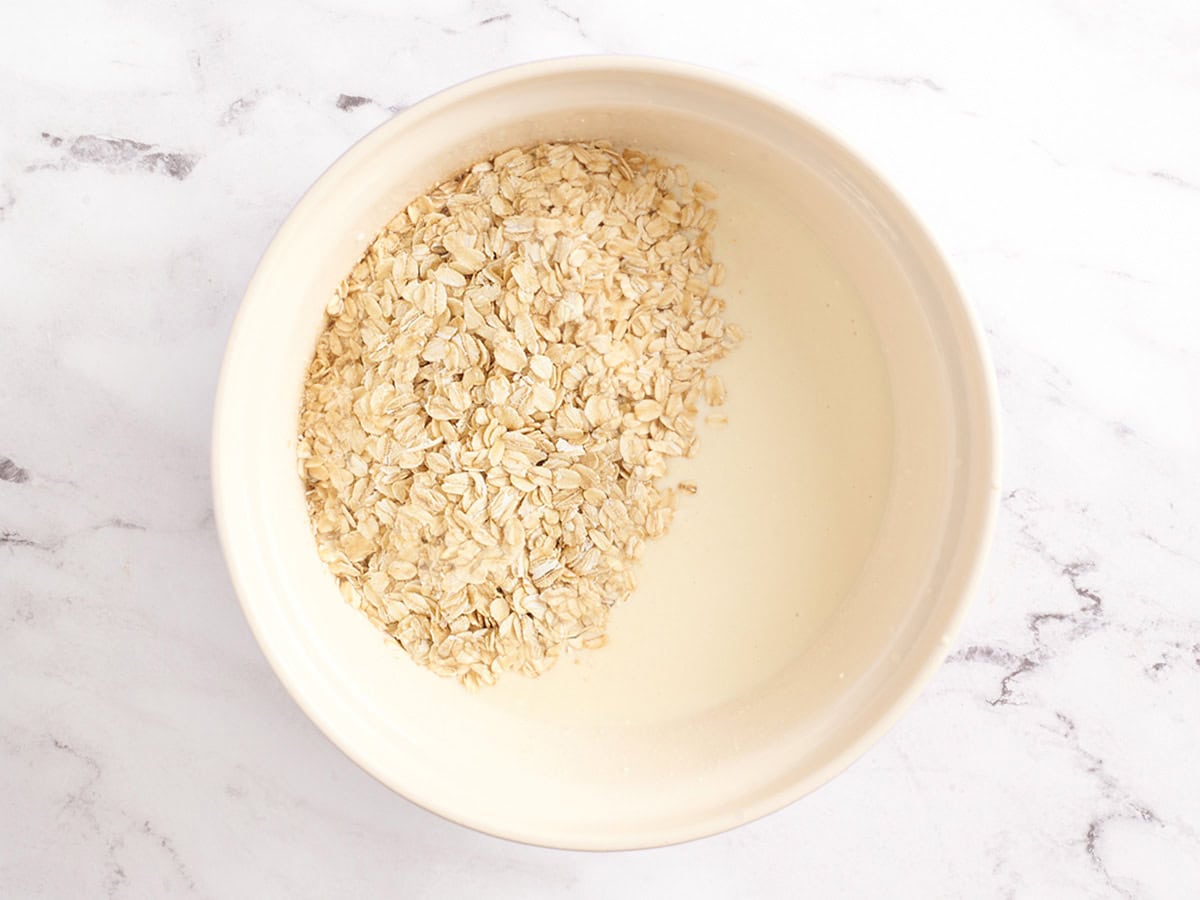 Oats added to the wet ingredients to make baked oatmeal.