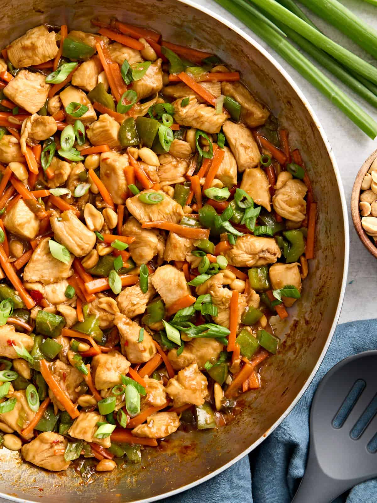 Overhead view of kung pao chicken in a skillet.
