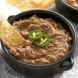 Not refried beans dip in a bowl with chips.