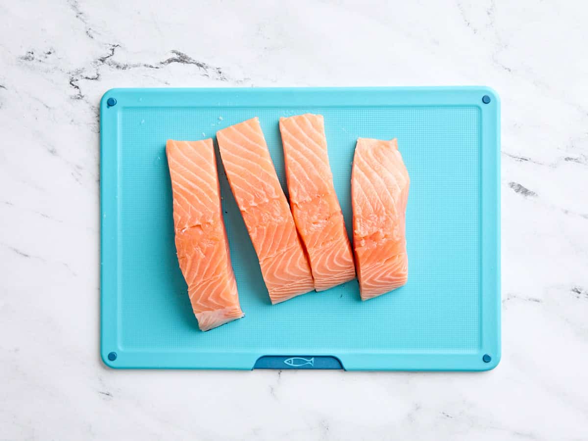 Sliced salmon on a cutting board.
