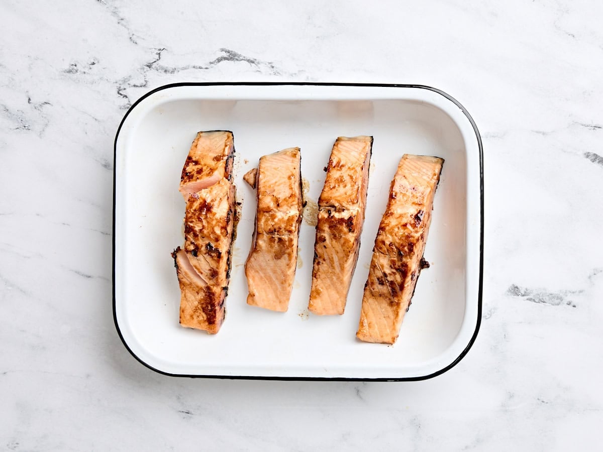 Pan fried teriyaki salmon in a baking dish.
