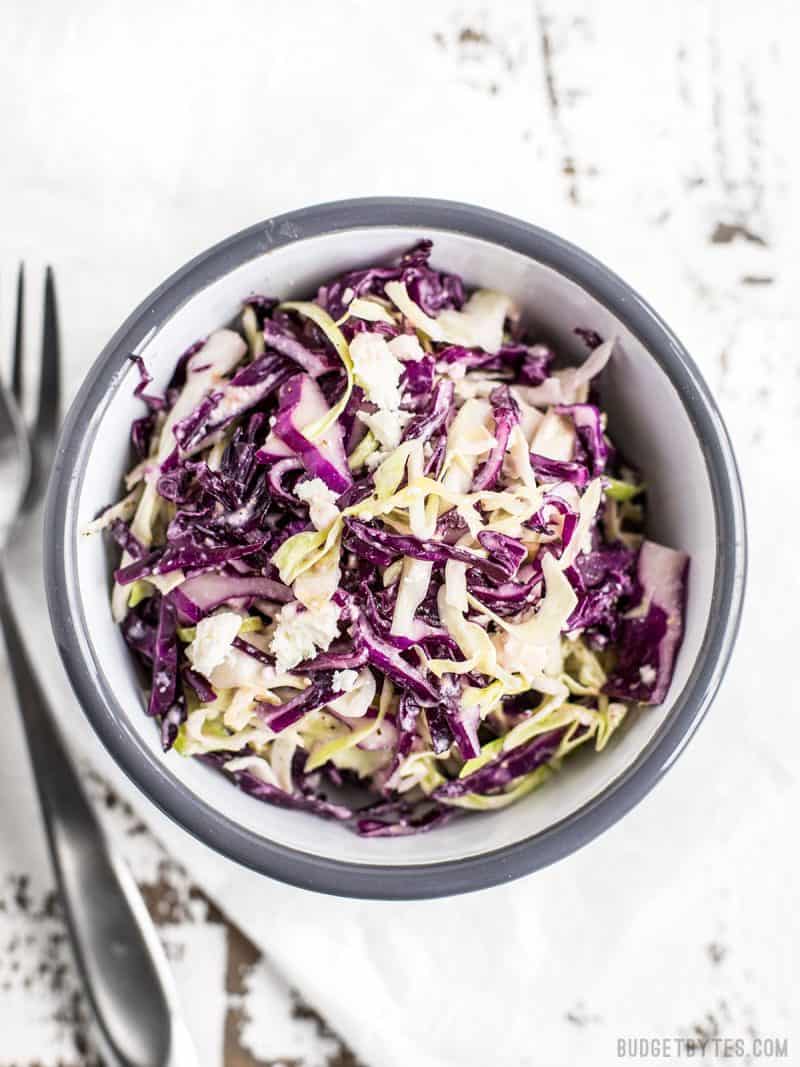 Top view of bowl of slaw with a fork on the side