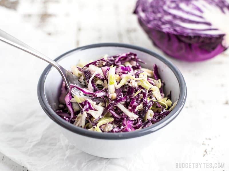 Small bowl of slaw in bowl with fork