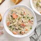 Overhead view of a bowl of creamy chicken and rice soup.