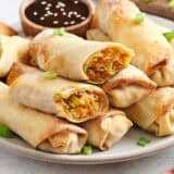 Side view of homemade vegetable egg rolls on a plate.