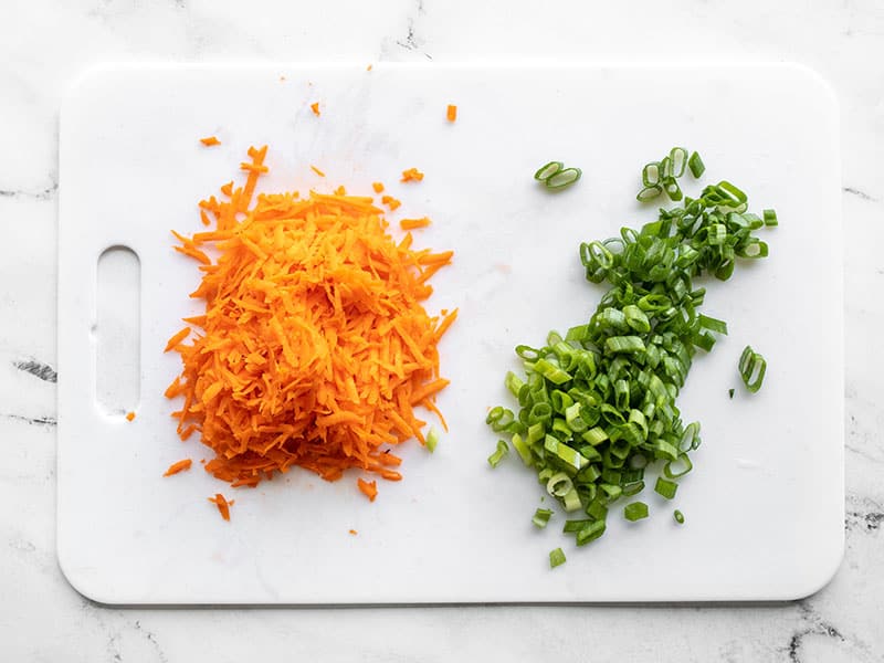 Shredded carrot and sliced green onion.