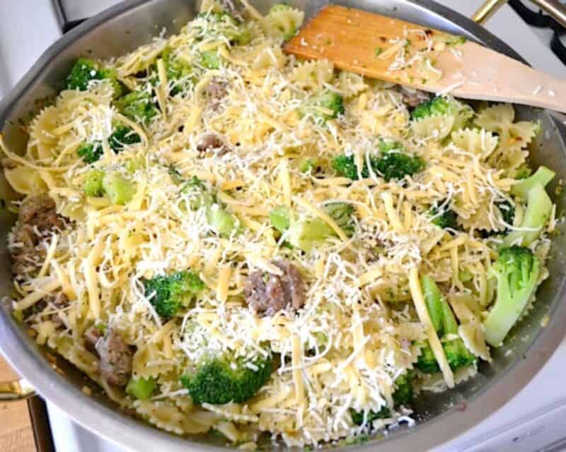 Cheese sprinkled over the pasta with broccoli and sausage.