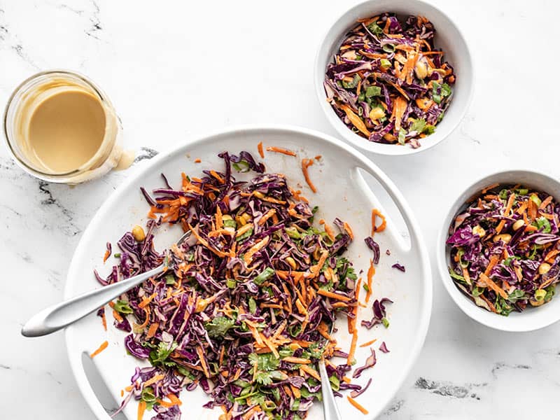 This crunchy cabbage salad holds up great in the refrigerator, so you can have a fresh crunchy vegetable side all week long! Budgetbytes.com Crunchy cabbage salad coated in dressing, dished out to two bowls.