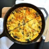 Kale and chorizo strata served on a cast iron pan.