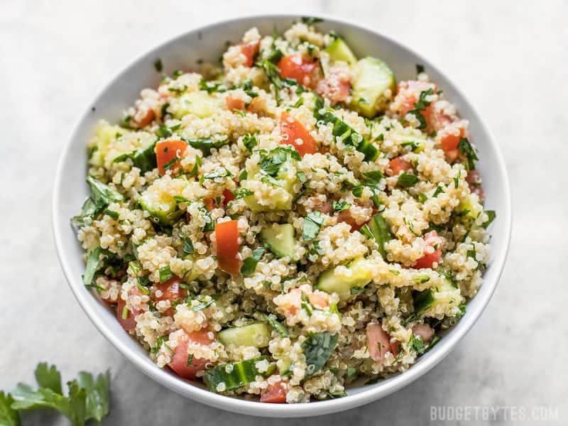 Fresh and vibrantly flavored, this Quinoa Tabbouleh has all the familiar flavors of traditional tabbouleh, but with quinoa instead of bulgur. Budgetbytes.com Front view of a bowl of Quinoa Tabbouleh