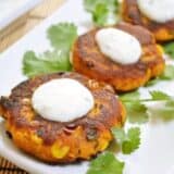 Sweet potato corn cakes drizzled with sauce.
