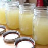Chicken broth in a clear bowl.
