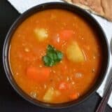 Red lentil stew served in a bowl.