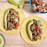 Quinoa and black bean tacos with toppings.