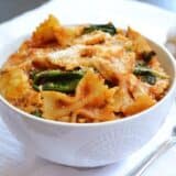 Zesty tomato and artichoke pasta served in a bowl.