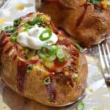 A BBQ beef stuffed potato served on a plate.