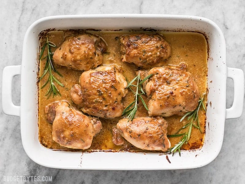 Top view of Baked maple dijon chicken thighs in baking pan