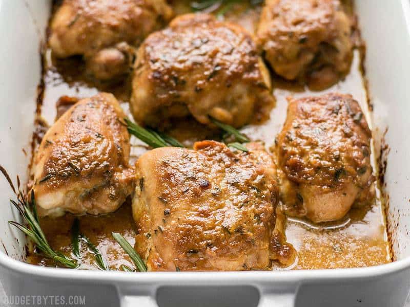 Close up of maple dijon chicken thighs in baking pan