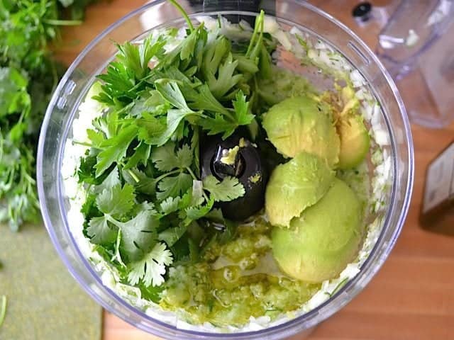 avocado, oil and herbs added to processor