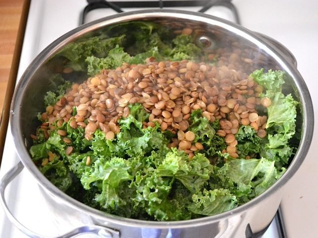 kale and lentils added to pot