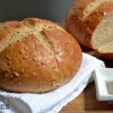 Loaf of honey sunflower bread on a cutting board.