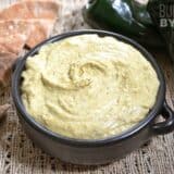 Roasted poblano hummus served with sliced bread.