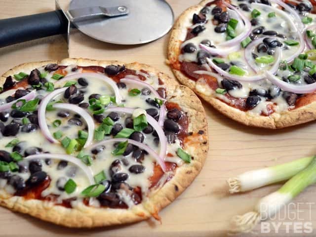 Two BBQ Black Bean Pizzas with pizza cutter to cut