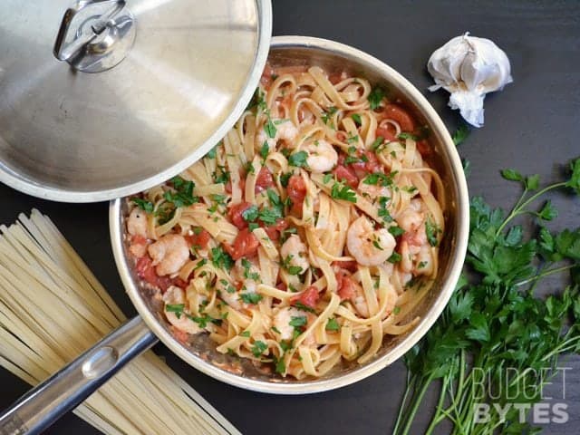 It takes less than 30 minutes to make this super flavorful and filling Spicy Shrimp Tomato Pasta. Dinner made FAST! BudgetBytes.com skillet Finished spicy shrimp tomato pasta in skillet