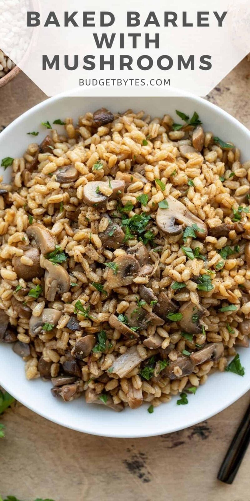 Overhead view of baked barley with mushrooms in a bowl, title text on top