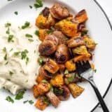 Oven roasted autumn medley on a plate with mashed potatoes and a black fork