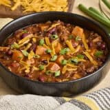 Side view of a bowl of chorizo sweet potato chili.