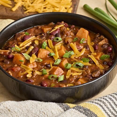 Side view of a bowl of chorizo sweet potato chili.