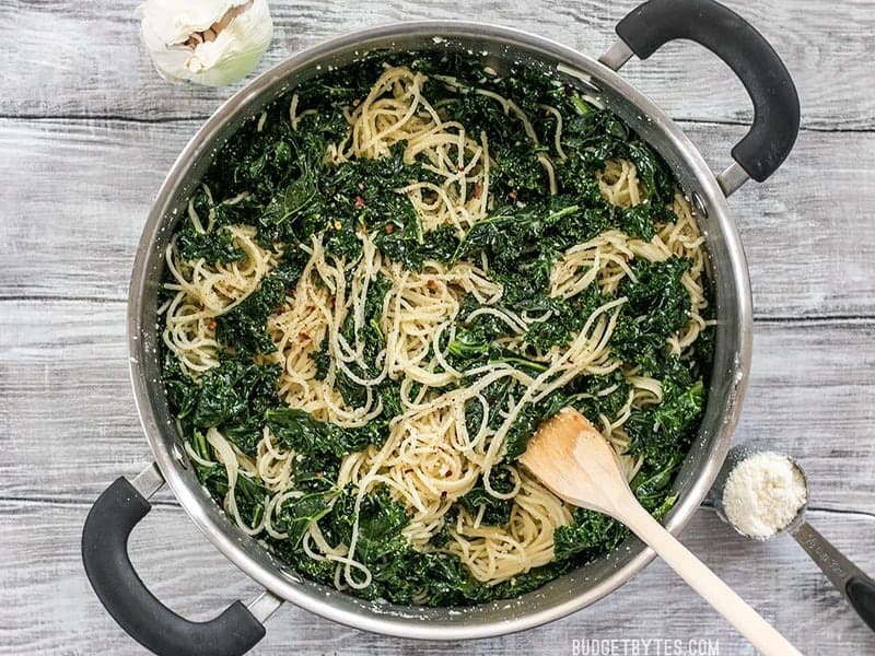 When you're in a hurry, this Garlic Parmesan Kale Pasta is a filling and flavorful meal. Few ingredients, BIG flavor. BudgetBytes.com Overhead shot of a finished pot of Garlic Parmesan Kale Pasta