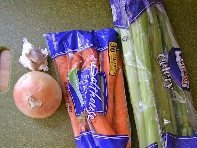 Vegetables (onion, carrots, celery and garlic) on countertop