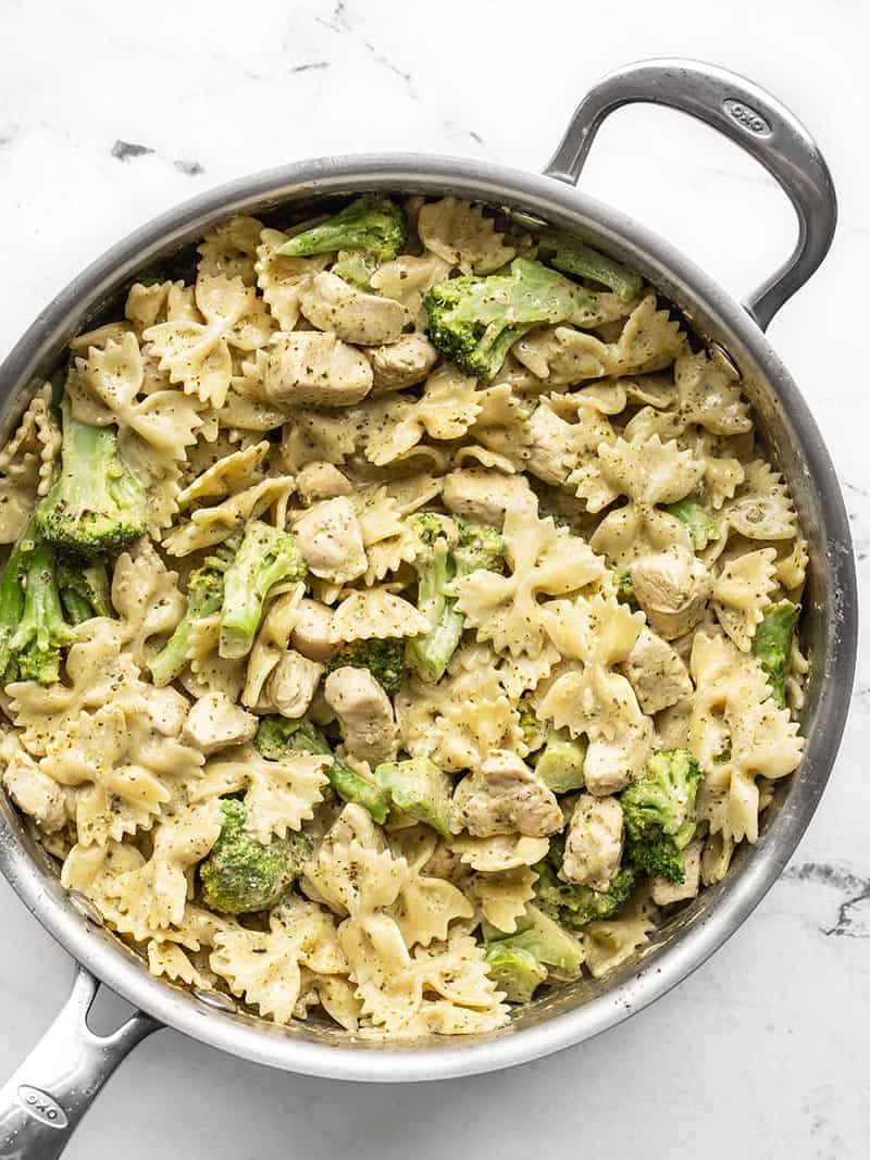 A super fast creamy pesto sauce drenches tender pasta, chicken breast, and broccoli for an easy weeknight dinner. Budgetbytes.com Creamy pesto pasta with chicken and broccoli in the skillet, viewed from above