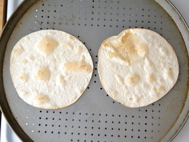 Golden brown Baked Tortillas on pizza pan